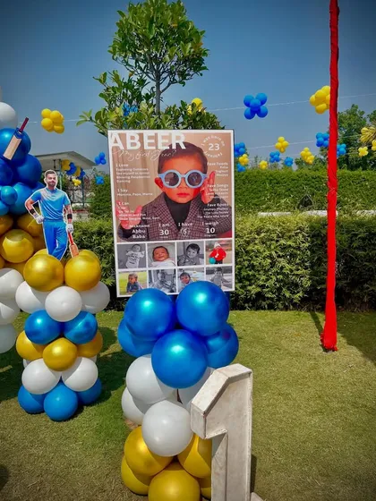 A personalized milestone board for the birthday boy, 'Abeer', surrounded by cricket-themed decorations.