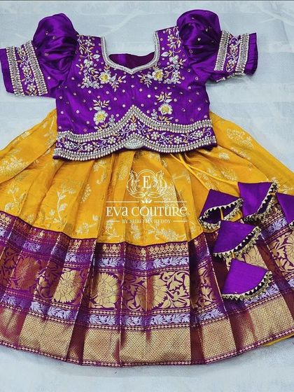 A flat-lay showing the intricate embroidery on the blouse and the rich texture of the Kanchi Pattu skirt.