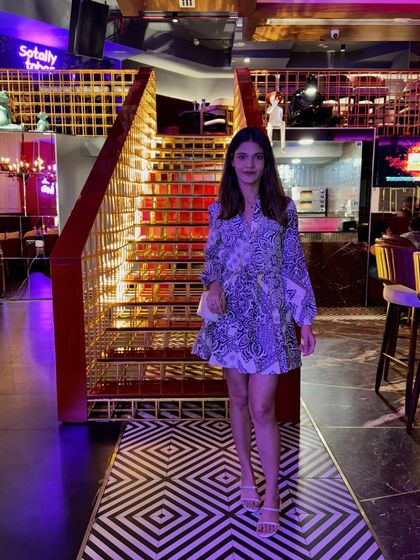 A full view of my printed dress against a geometric black and white floor. The pattern play between the dress and the floor creates a dynamic and interesting photo.