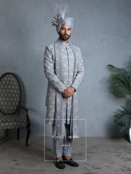 The full look of the powder blue sherwani with its matching stole. The hand-embroidered florals and regal accessories make it a statement of unmatched elegance.