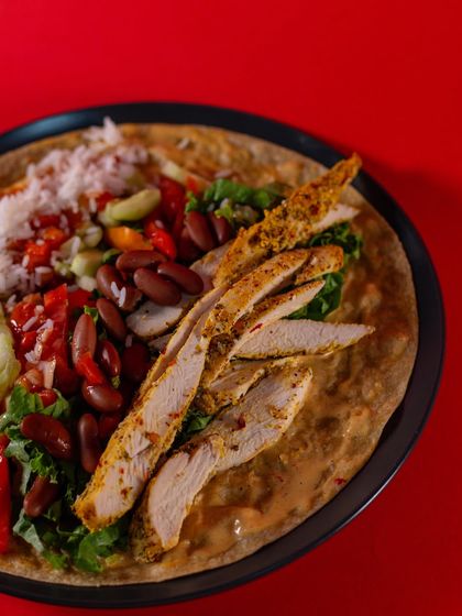 A close-up of the Chicken Burrito Wrap fillings. You can see the perfectly cooked chicken strips, red kidney beans, and fresh pico de gallo, all ready to be wrapped up.