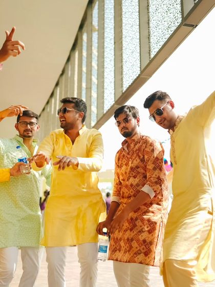 The groom's squad enjoying the poolside festivities. The yellow color theme of the Haldi was reflected in the guests' attire, adding to the vibrant visual tapestry of the day.