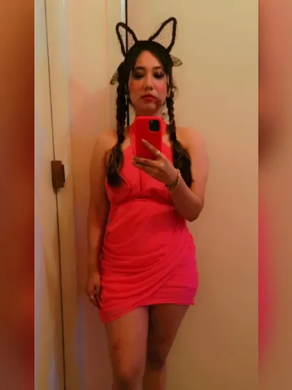 A full-length mirror selfie of the Evil Barbie costume. This bright pink outfit stood out and added to the fun of the Halloween party.