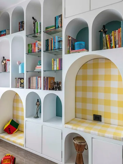 I delight in creating spaces that spark imagination. This arched book unit in a Mumbai duplex transforms a child's bedroom into a whimsical haven. It’s more than storage; it’s a centerpiece with integrated reading nooks designed to foster a lifelong love for stories.