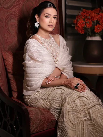 A client looking radiant and timeless in the ivory sharara set, a captivating style for any special occasion.