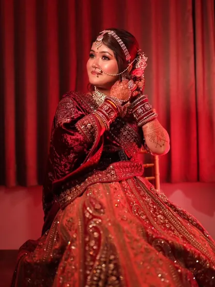 A full-length shot capturing the bride's regal presence. The rich velvet lehenga and perfectly draped dupatta create a look of timeless beauty.