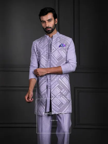 A canvas of modern elegance. A longline kurta flows with refined grace, while a looped tunic adds charm and textured bell-bottoms bring rhythm, creating a symphony of contemporary poetry.