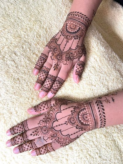 A clear shot of the matching guest mehndi designs, highlighting the clean lines and detailed motifs.
