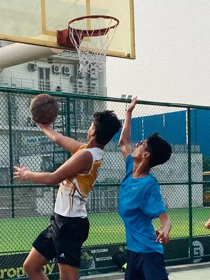 A close-up of a contested layup, showing the focus required to finish through contact. We train players to be aggressive and attack the rim.