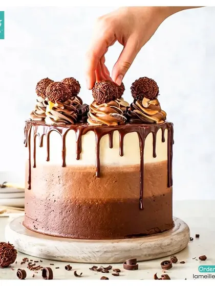 Our triple-layer chocolate drip cake is a dream for any chocoholic. It features shades of rich chocolate frosting, a decadent drip, and is topped with swirls and Ferrero Rocher for that extra touch of indulgence.