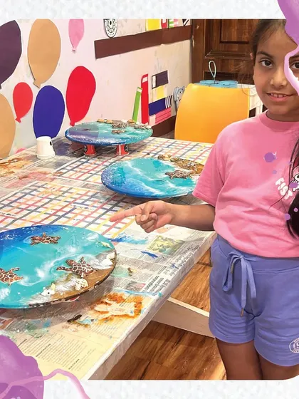 The finished masterpieces! A student proudly points to the collection of resin art pieces created during our weekend workshop. The glossy finish and vibrant colors are always a huge hit.