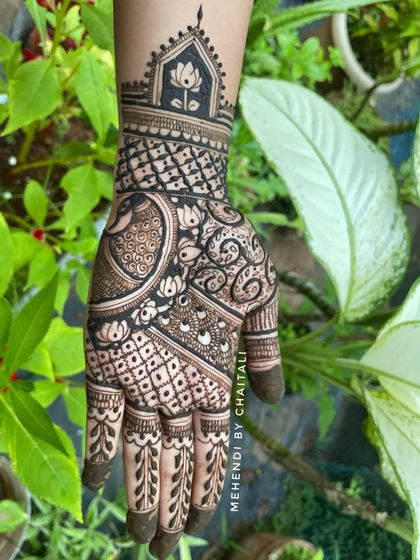 A semi bridal design featuring a prominent peacock, a lotus motif in a jharokha, and a mix of jaali and floral patterns. This is a great option for siders or smaller functions.