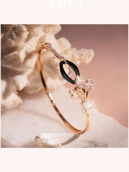 An Italian-designed bracelet that combines modern materials and classic form. This piece features a touch of black ceramic and sparkling CZ diamonds set in a polished rose gold cuff.