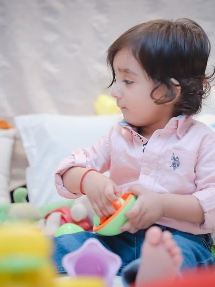 Focused on his toys. We capture children engrossed in play, showing their concentration and curiosity.