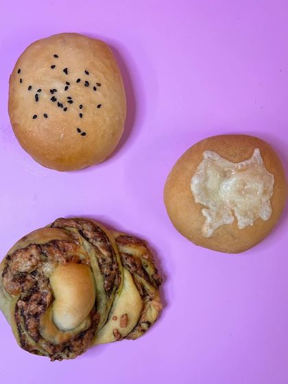 A sneak peek of our savory menu development. We've got mushroom pizza buns, chicken masala buns, and pesto cheese braids. Can't wait for you to try them all.