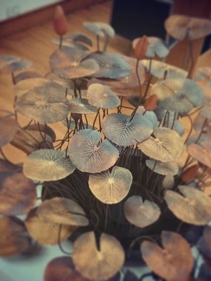 This is a metal sculpture of a lotus pond by Gopinath S, seen here as we prepared it for a viewing at the gallery. It is a large, immersive piece that brings the tranquility of nature indoors.