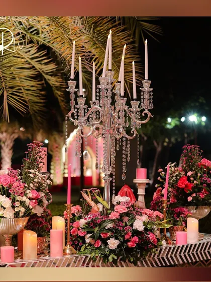 A stunning tablescape featuring a crystal candelabra and arrangements of pink flowers, creating a look of pure romance and elegance.