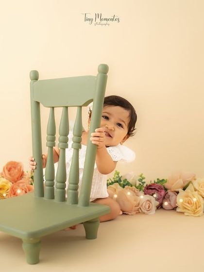 A wide shot showing the full setup, with the little one playfully hiding. This gives a sense of the scale and beauty of the studio arrangement.