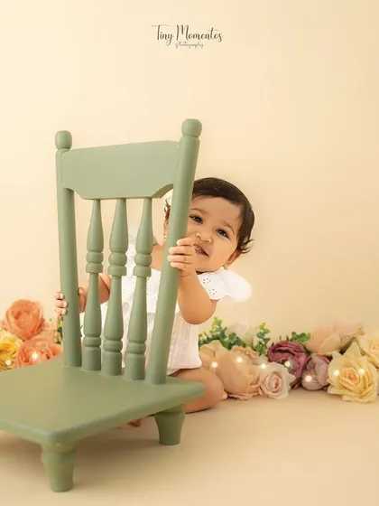 A wide shot showing the full setup, with the little one playfully hiding. This gives a sense of the scale and beauty of the studio arrangement.