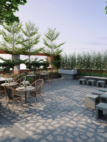 This rooftop cafe and seating area provides a social hub with panoramic views. We used a mix of natural materials, comfortable furniture, and lush planters to create an inviting, resort-like atmosphere.