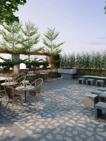 A render of a rooftop terrace and cafe, designed as a social hub for residents. This outdoor amenity space provides a beautiful setting for relaxation and community gatherings, surrounded by lush greenery.