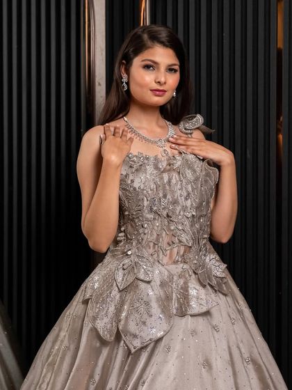 Another angle of our silver-grey appliqué gown, showing how the structured details create a unique and artistic look. Perfect for making a fashion statement.