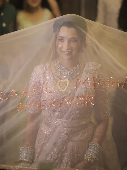 A creative entry with a custom veil. The bride looks magical behind the sheer fabric.
