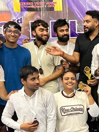 A candid moment of celebration with the team after a tournament. The smiles and medals are proof that our hard work in the gym pays off.