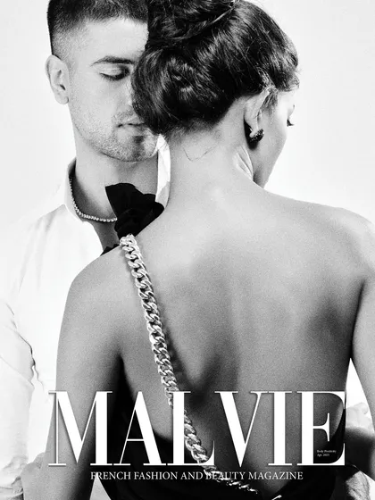 This black and white cover for Malvie Magazine captures a moment of quiet intimacy. The composition focuses on the elegant chain strap of the dress and the subtle interaction between the couple, proving that powerful accessory stories can be told with subtlety.