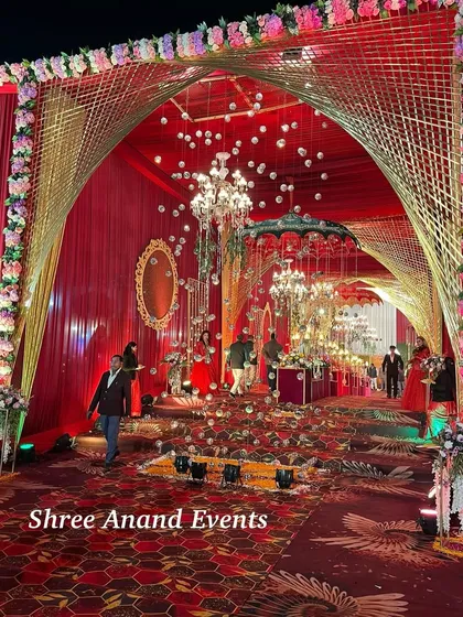 A stunning entrance featuring a golden arch, hanging chandeliers, and floating spheres, creating a multi-dimensional and magical welcome.