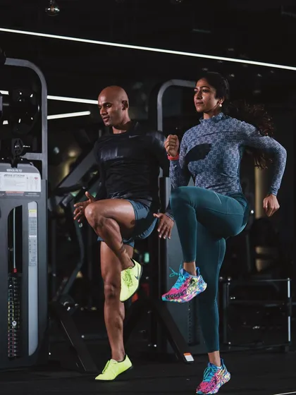 In sync during a dynamic warm-up. High-knee drills like this are perfect for activating the core and leg muscles before a heavy lifting session.
