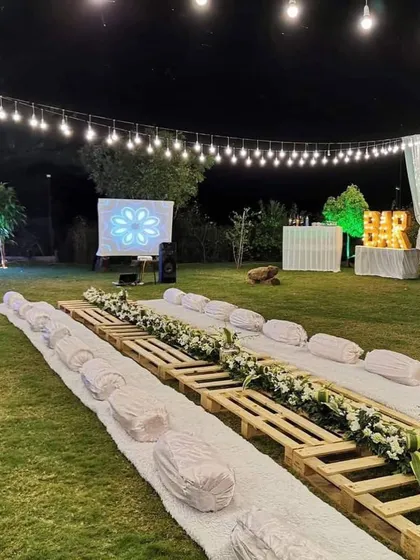 We transform any location into a beautiful dining experience. This elegant sit-down arrangement by the pool was for a private farmhouse party in Nashik, showing our capability to handle destination event catering with style.