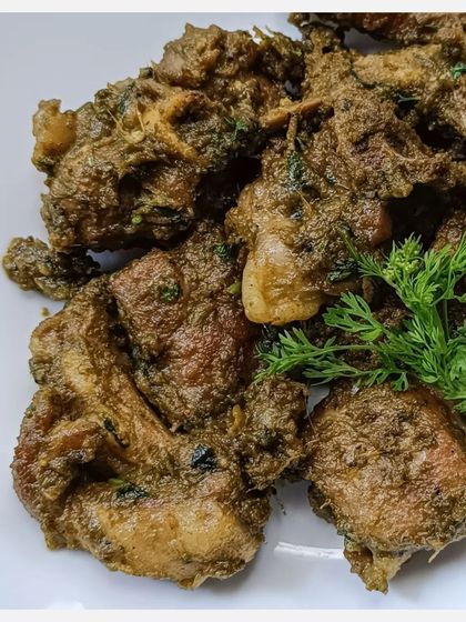 A close-up of the Karnivore Bannur Mutton Fry, showing the texture of the slow-cooked meat and the rich masala.