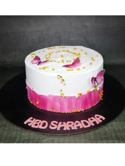 A minimalist cake with a fresh mango flavor, filled with delicious Alphonso mangoes. The simple pink brushstroke effect and delicate butterflies create an elegant look.