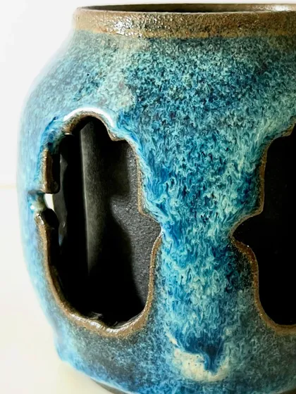 A close-up detail of the reactive blue glaze on the Hamsa mug. I love how the glaze breaks over the edges of the carving, highlighting the texture and creating unique patterns.