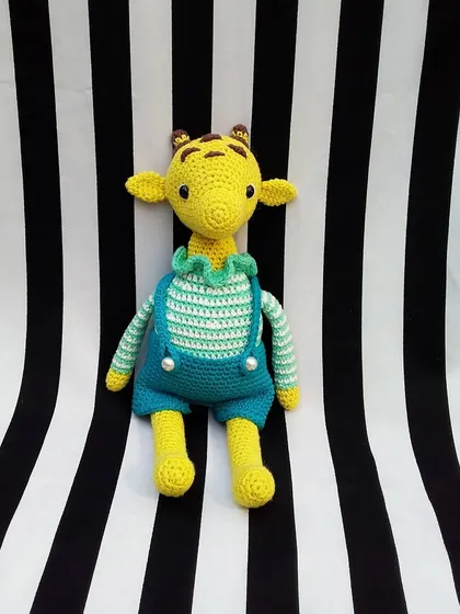 This is George the giraffe, all dressed up in his striped shirt and overalls. I think he looks very dapper and cute.