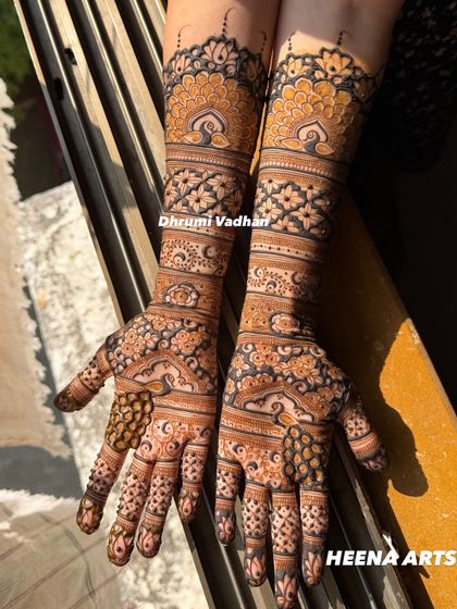 A beautiful design with peacock and floral motifs, captured in the golden hour sunlight which makes the henna pop.