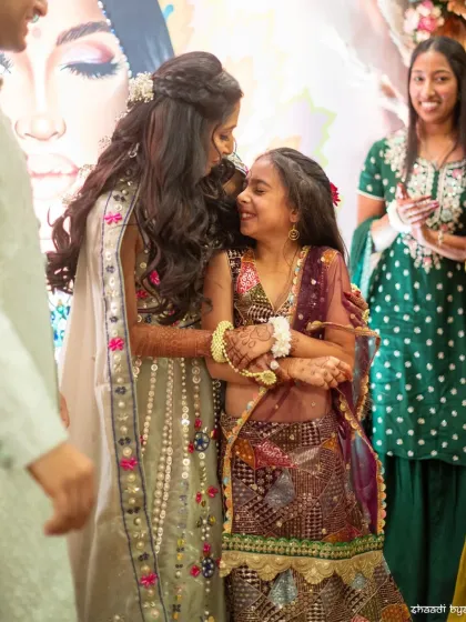 A tender moment between the bride and a younger family member during the Mehendi.