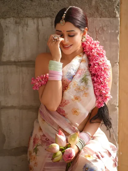 A shy, happy expression captured beautifully. This image emphasizes the "masoom chehra" or innocent face concept we aimed for, enhanced by the soft lighting and floral elements.