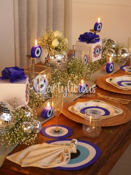 Here is a look at my 'Evil Eye' themed table setting, a unique concept for a dinner or party. I mix deep blues and protective symbols with the modern sparkle of disco balls and soft florals to create an atmosphere of chic protection and good vibes.