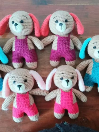 A family of six handmade puppies, each with different colored ears and overalls.