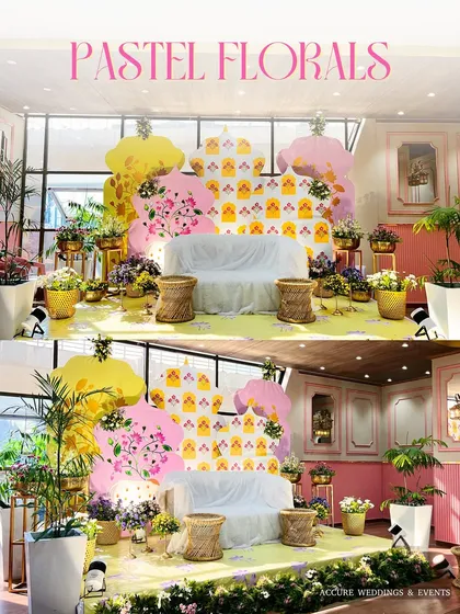 The main seating area for the Mehendi, with a custom backdrop featuring pastel florals and a playful pattern.