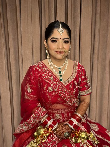 The lovely Jaya, ready for her pheras. A classic red lehenga paired with soft, glowing makeup for a timeless bridal look.