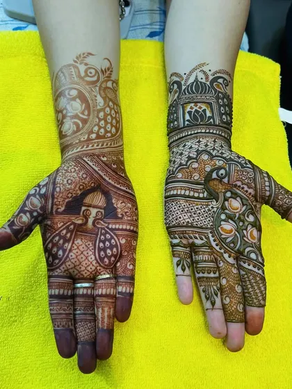 A stunning example of festive mehndi, combining peacock and architectural elements for a grand look.