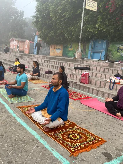 Students meditating on the steps of the ghat in Haridwar, absorbing the spiritual energy of the place.