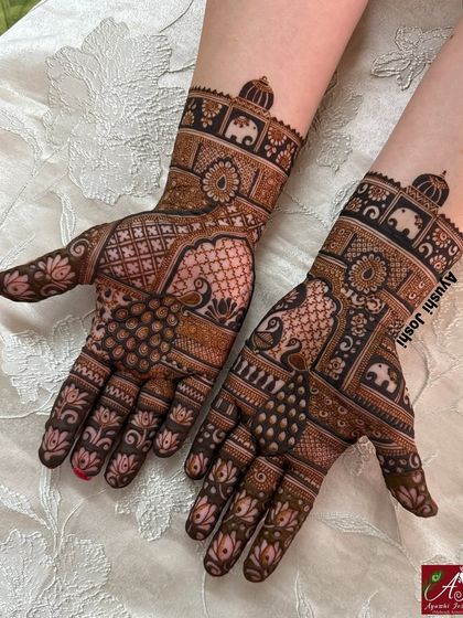 An Indian designer mehendi for the groom's sister, featuring peacocks, elephants, and lotuses.