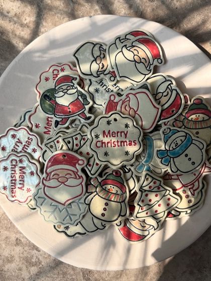 My Christmas charms catching the morning light. Each one is hand-cut and painted, making them tiny, unique works of art.