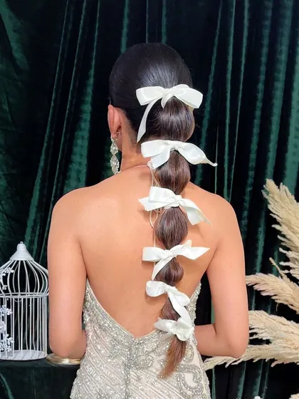Another angle of the bow-adorned balloon braid, showing its volume and structure.