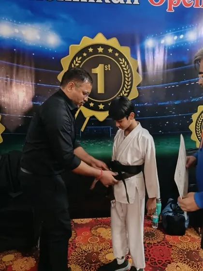 The moment a black belt is tied, signifying a major accomplishment in a martial artist's life. We are incredibly proud of Ishaan's journey and perseverance.
