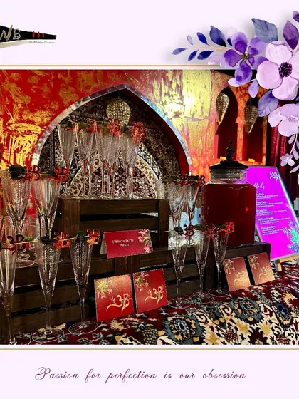 A regal bar setup featuring custom coasters and glass markers, designed to match the opulent theme of the wedding at Leela Delhi.